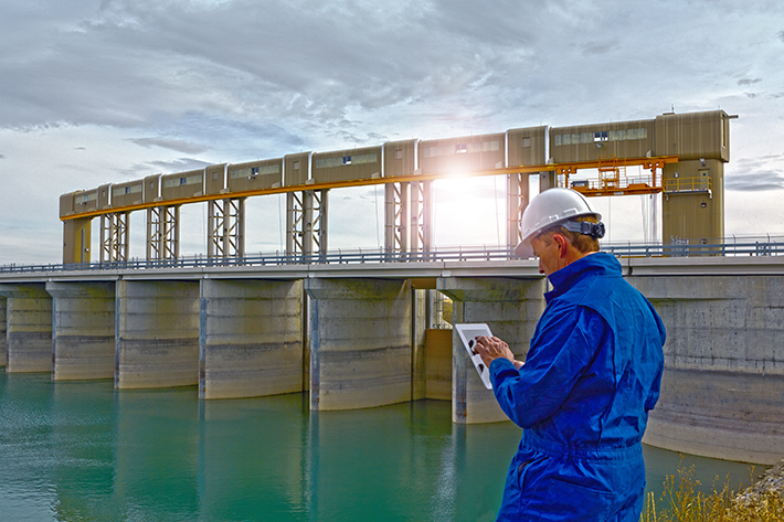 Hydroelectric Dam Inspected by Engineer